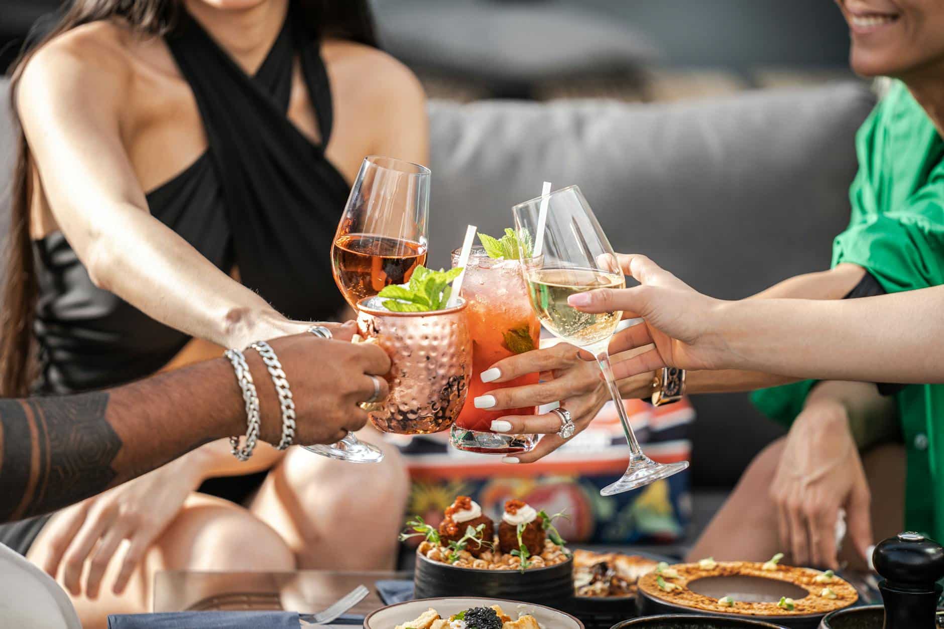 friends drinking cocktails on a terrace